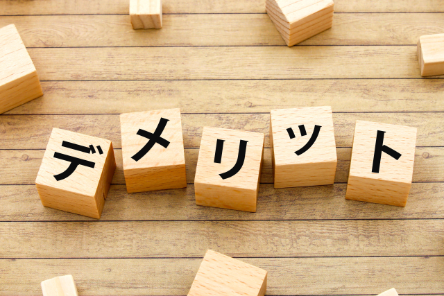 デメリットの文字 木製の四角いブロック